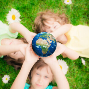 Children,Holding,3d,Planet,In,Hands,Against,Green,Spring,Background.